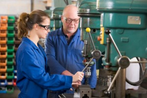 Two machinists working on machine